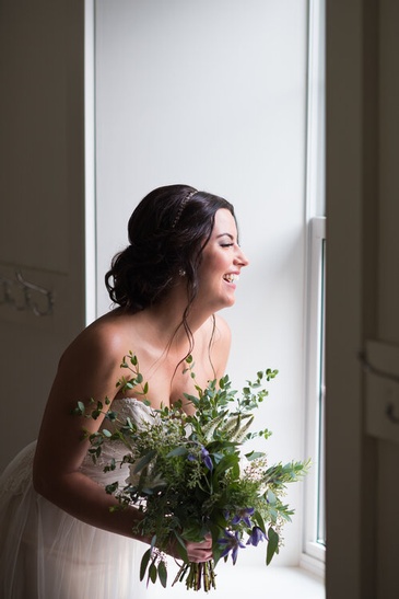 Happy Bride near window Captured by Wedding Photographer Saugeen Shores