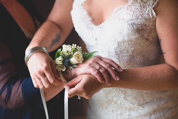 Bride tying Flower Wrist Corsage - Wedding Photography Burlington by Devon Crowell